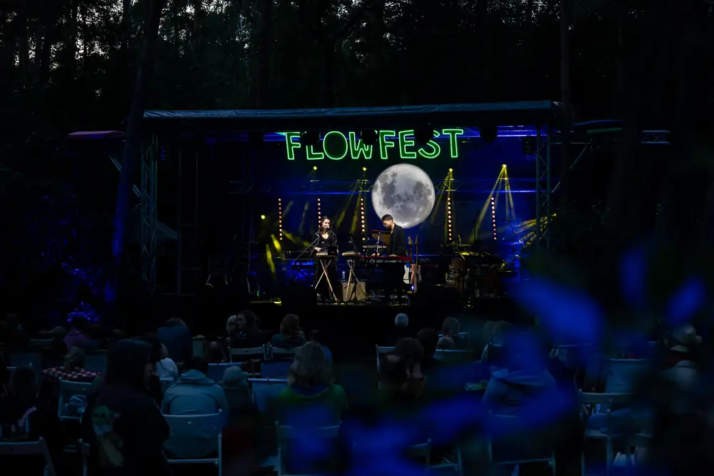 Wieczorny koncert na scenie plenerowej, widownia przy stolikach